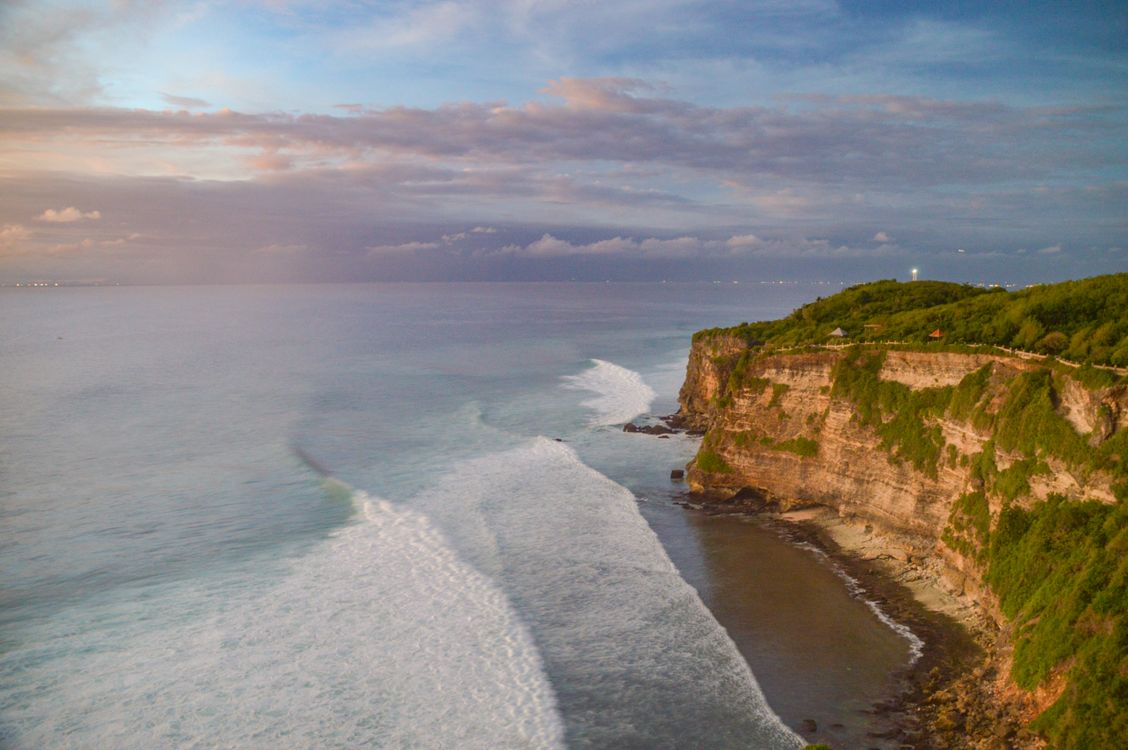 Cliffside view in Uluwatu, Bali at sunset overlooking the Indian Ocean