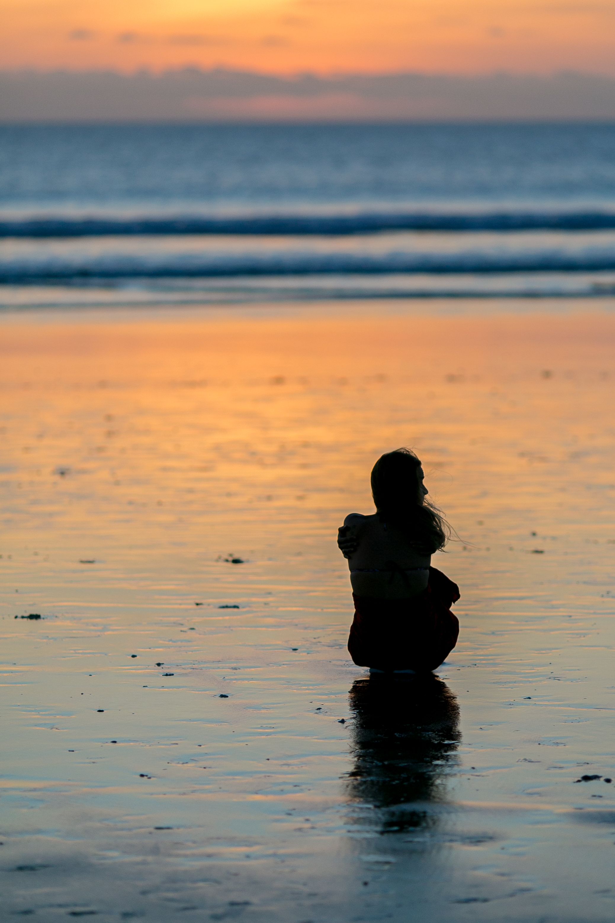 Silhouette of person on a beach at sunset